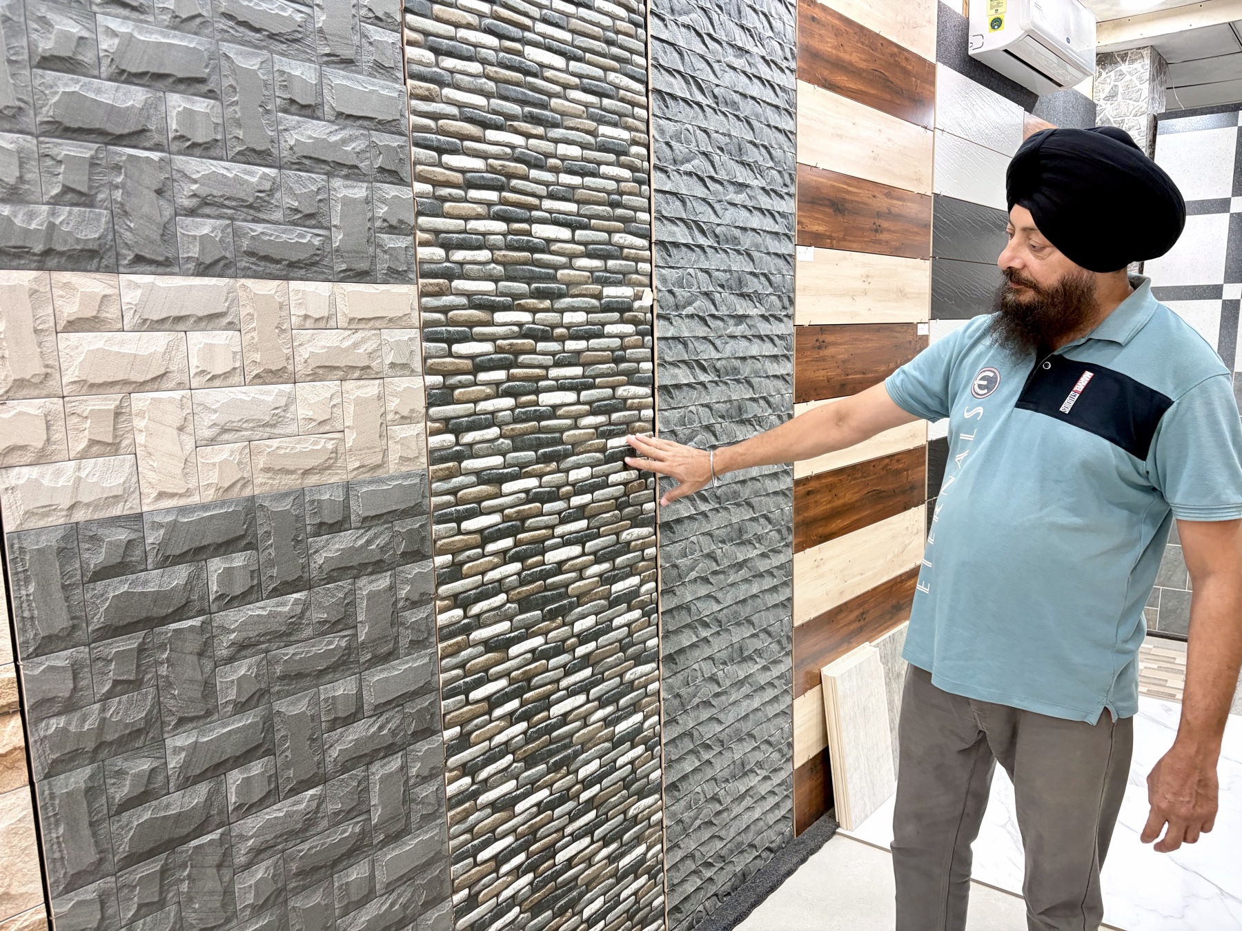 Ravinder Bir Singh showing tile finishes at The Tile Network